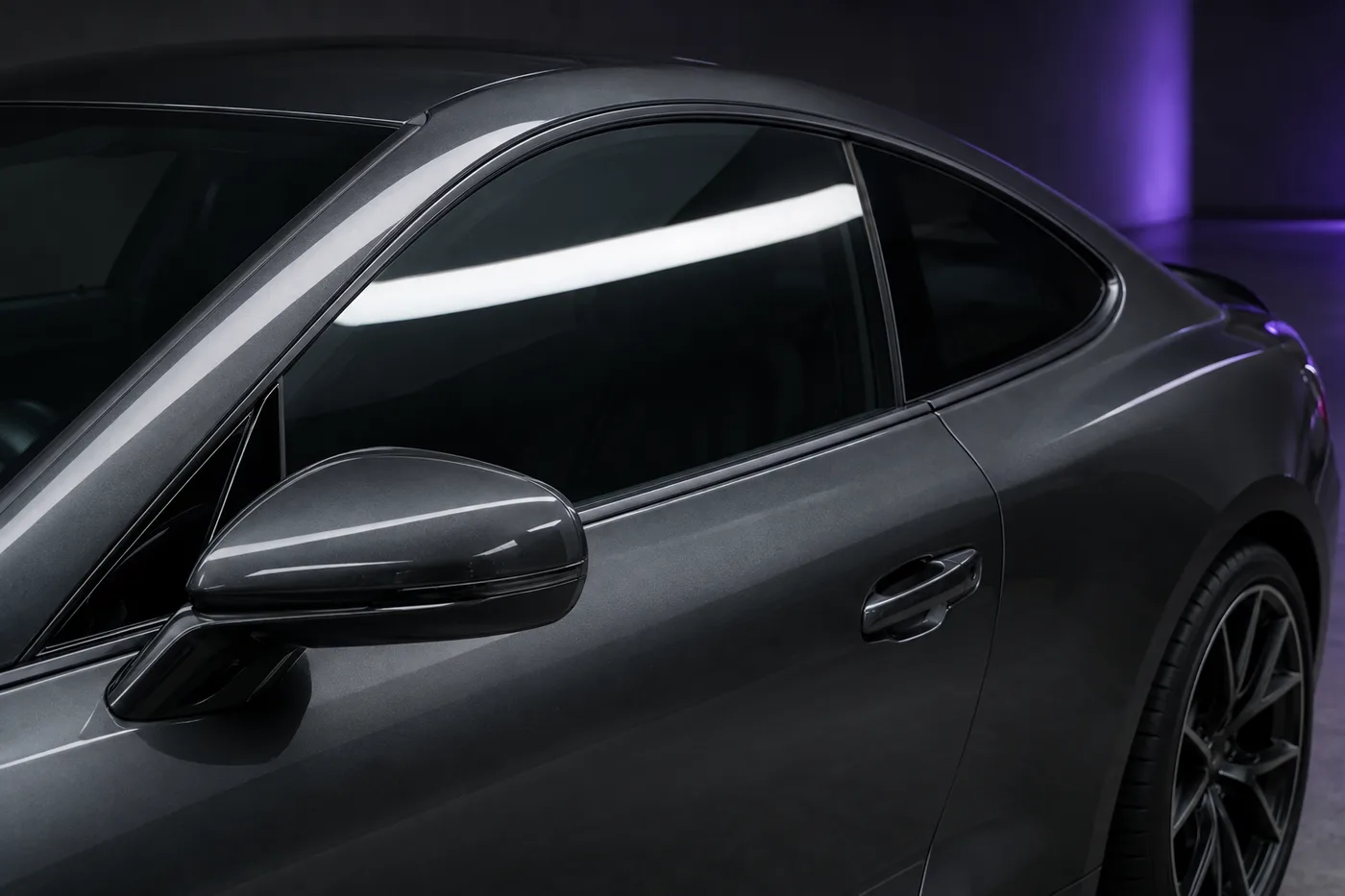 Illustrative close-up of tinted glass on a graphite coupe