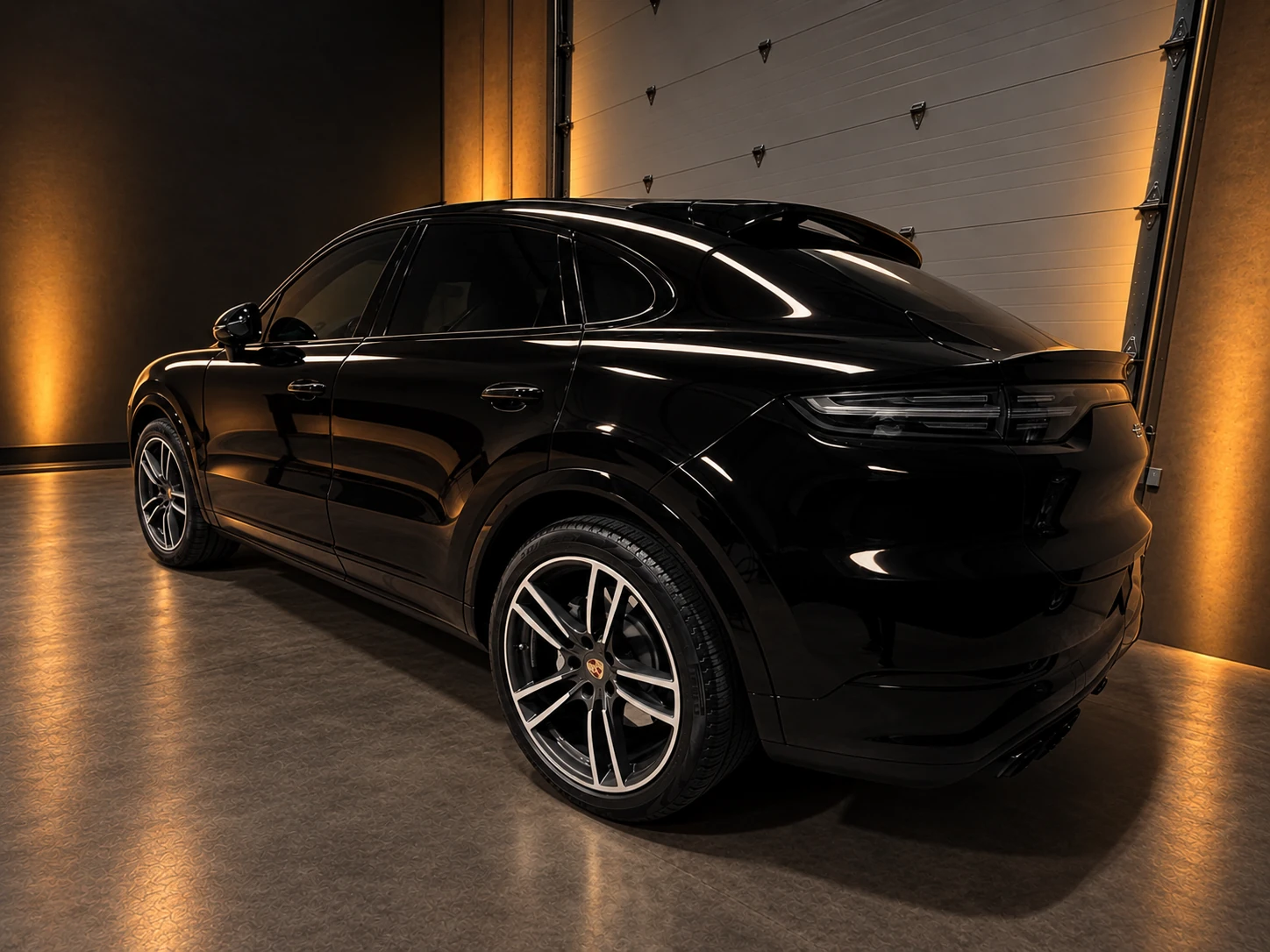 Rear three-quarter view of a black Porsche Cayenne Turbo inside the PLM studio